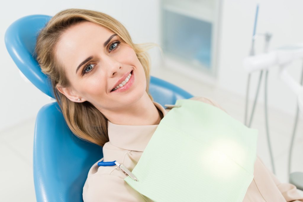 Smiling woman at check-up in modern dental clinic