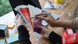 Team of creative designer choosing colors from palette guide for their new project.